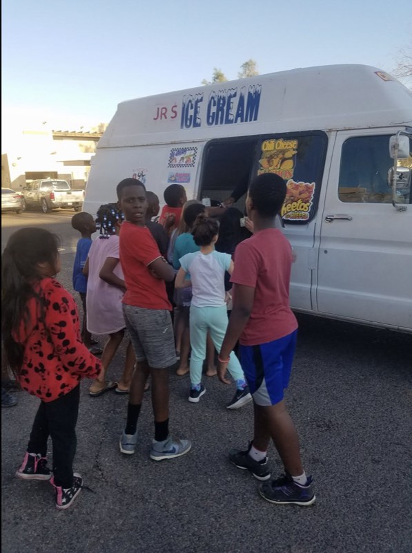 Neighborhood kids gathered around the family ice cream truck
